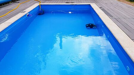 Swimming pool cleaner robot during vacuum service, maintenance.の写真素材