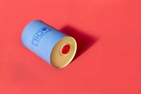 Metal barrel of oil with text "oil" on red background. Concept of oil market production, global financial crisis.の写真素材