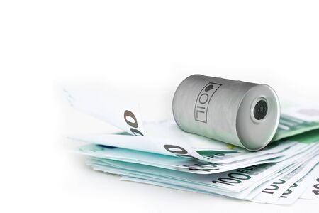 Metal barrel of oil with text "oil" on pack euro money banknotes as background. Concept of oil market production, global financial crisis.の写真素材