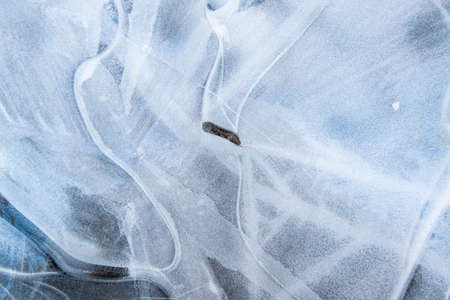 Beautiful abstract icy background. Natural texture of light blue ice structure and snow