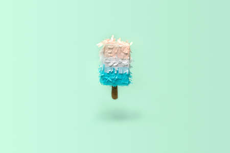 Paper creative decoration on abstract pastel blue background. Ice cream in minimal style. Creative Xmas concept.の写真素材