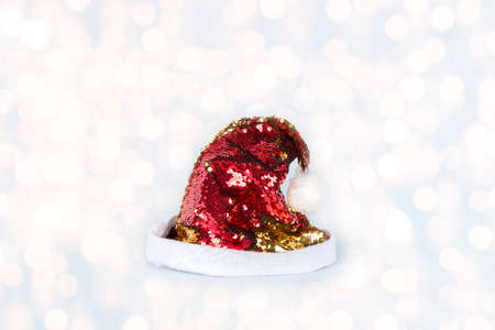 Santa Claus hat on Christmas blurred lights background. Happy New Year celebration.の写真素材