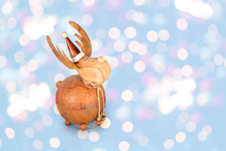 Christmas bauble deer on shiny blue background. Happy New Year celebration