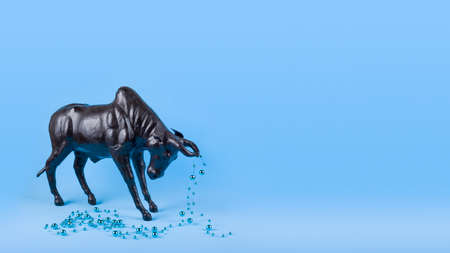 Ox with Christmas ball on horns on blue background, banner. Buffalo, bull as symbol of year 2021 to...