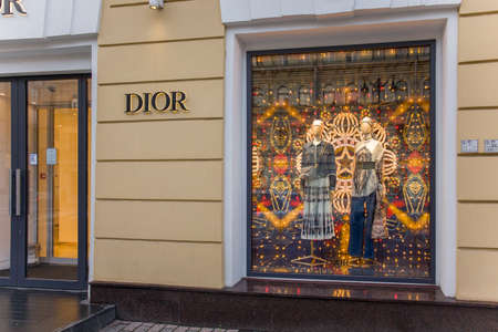SAINT PETERSBURG, RUSSIA - NOVEMBER 24, 2020: Show window of Dior fashion store, decorated in Christmas style with bright golden lights. Boutique shop in Saint Petersburg, Russia. High quality photoのeditorial素材