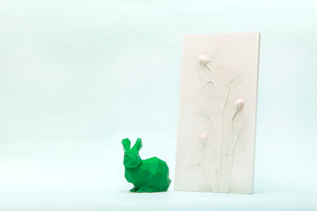 Botanical bas-relief wildflowers and poly low easter bunny for wall art. 3D Flower plaster decor. Stylish and modern interior of room. Happy Easter holiday concept in minimal style. High quality photoの写真素材