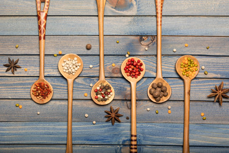 Set of spice mixes in wooden spoons on dark wooden table. Top view, flat layの写真素材