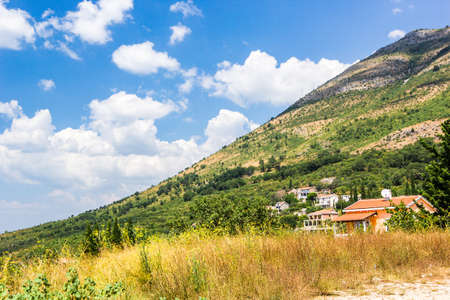 Panoramic view of beautiful landscape mountains and of small haven of village, Adriatic coast, Montenegroの写真素材