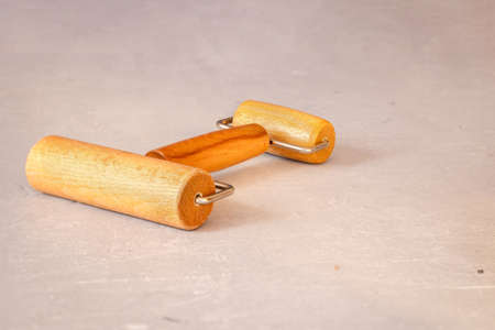 Wooden double-sided roller for rolling out dough or clay on marble table. Professional working tool. High quality photoの写真素材