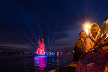 Holiday SCARLET SAILS 2021. Sailboat with scarlet sails sails on Neva River. Fireworks and beams of searchlights in White Nights for high school graduates.のeditorial素材