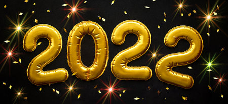 Happy New Year 2022 celebration. Gold balloons in form of numbers with shiny sparkle on festive on black background. Flat lay, top view, bannerの写真素材