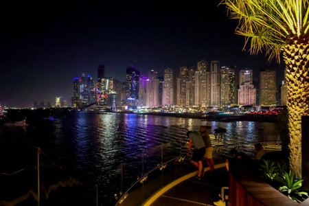 Bluewaters Island at night. Walking area promenade with huge neon glowing trees mushrooms. Jumeirah Beach Residence coastline. Dubai Marinaのeditorial素材
