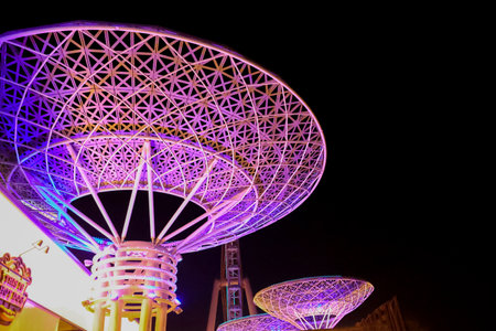 Bluewaters Island at night. Walking area promenade with huge neon glowing trees mushrooms. Jumeirah Beach Residence coastline. Dubai Marinaのeditorial素材