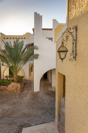 Exterior of house in oriental style. Architecture traditional old yellow Arabic house with arches and stairs in minimalist style, Sharm El Sheikh, Egyptの写真素材
