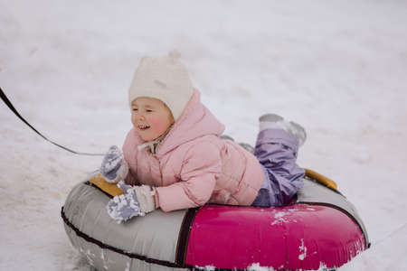 Dad giving high five little girl on walk in winter snowy day.の写真素材