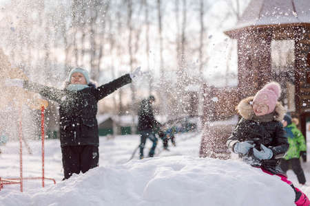 Little girls walks outdoors on winter snowy day in park. High quality photoの写真素材