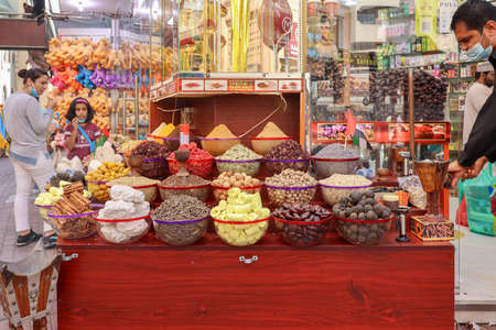Dubai, UAE - November 29, 2021: Traditional spices market. Pots and wooden tubs stand in row with colorful tea, spices, fruits, roots, flowers. Street bazaar.のeditorial素材