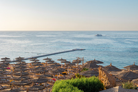 Panoramic view of beach Ras Umm El Sid. Beautiful sunrise over Red Sea with rocky shores, sandy...