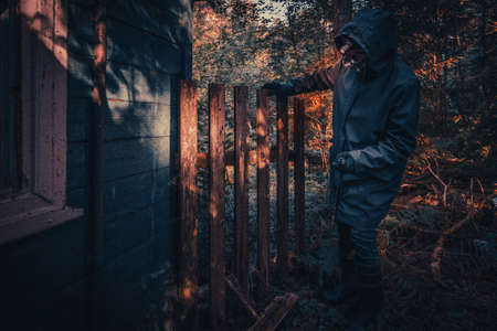 Fictional movie poster. People with flashlights, masks and protective clothing inspect old house. Infected epidemic people in destroyed home. Dark gloomy environment, filter processing.の写真素材