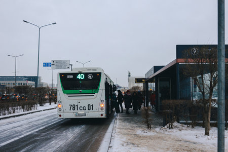 Astana, Kazakhstan - November 23, 2022: People waiting for public transport. Heated bus stops with air conditioning. Warm in winter, cool in summer.のeditorial素材