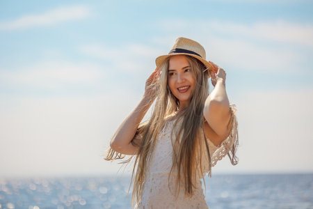 Portrait of girl in beach hat on summer day outdoors. high quality photoの写真素材