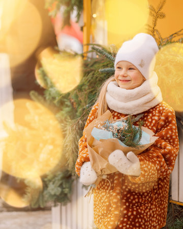 Russia, St. Petersburg - December 25, 2022: Happy girl at Christmas market on Nikolskie Ryady, St. Petersburg. Xmas holidays. Selective focus.のeditorial素材