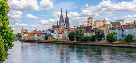 Panoramic view of Regensburg. Stone Bridge with Danube River with reflections of houses in water. Cathedral of St. Peter and Bridge Tower, Regensburg, Bavaria, Germany. High quality photoの写真素材