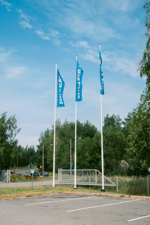 Helsinki, Finland - August 22, 2022: Three BILTEM flags fluttering in wind at entrance of Swedish store of spare parts, household goods on natural backgroundのeditorial素材