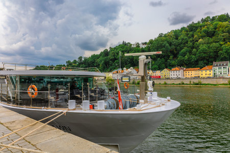 Passau, Germany - July 21, 2023: River ships, boats and powerboat moored on banks of Danube Riverのeditorial素材