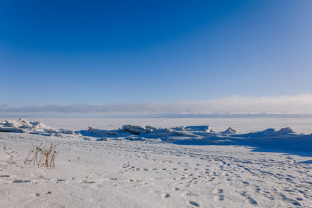 Beautiful winter landscape. Field of white snow and ice on horizon. Light and airy feel and light...