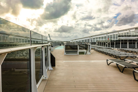 Italy, Rome - November 28, 2023: Beautiful view of deck with rows of sun loungers and swimming pool from MSC WORLD EUROPA cruise ship. Port of Civitavecchia Mediterranean coastlineのeditorial素材