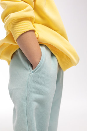 Portrait of beautiful cute little toddler girl. Child with funny face in yellow sweatshirt. Pretty smile kid in studio on white background. High quality photoの写真素材