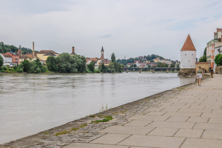 Passau, Germany - July 21, 2023: Panoramic view Schaibling Tower and promenade on river Inn, Passau, Lower Bavaria, Germanyのeditorial素材