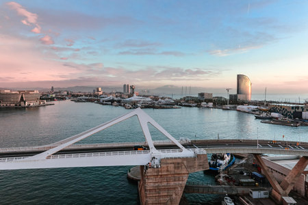 Barcelona, Spain - December 1, 2023: Panoramic view of cargo port in Barcelona. Freight transportation by container ship in harbor morning at dawn with beautiful sky with cloudsのeditorial素材