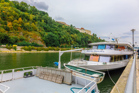 Passau, Germany - July 21, 2023: River ships, boats and powerboat moored on banks of Danube Riverのeditorial素材