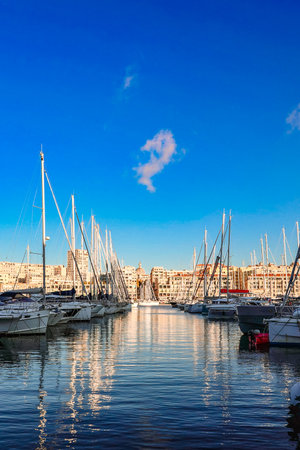 Panoramic view of old port of Marseille with yachts reflected in water, Marseille, France