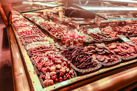 Barcelona, Spain - December 1, 2023: Barcelona market on La Rambla street. Spanish cured ham hanging in Boqueria Marketのeditorial素材