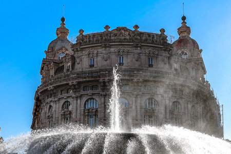 Main fountain with splashes of water in Ferrari Square against backdrop of beautiful architecture of...