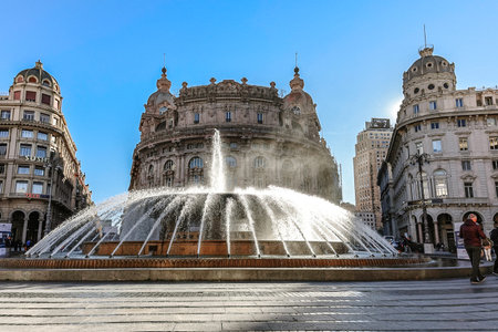 Genoa, Italy - December 3, 2023: Main fountain with splashes of water in Ferrari Square against backdrop of beautiful architecture of city. Piazza de Ferrari in Genoa, Liguria, Italyのeditorial素材