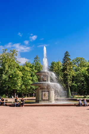 St. Petersburg, Russia - August 23, 2023: Fountains of Peterhof. View of Roman fountains in Lower park of Peterhof. Beautiful garden with green grass, shrubs and flowers and decorative treesのeditorial素材