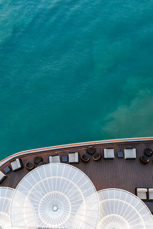 Top view of sea and water of sailing ship. Lounge promenade deck on cruise liner, vertical photo.