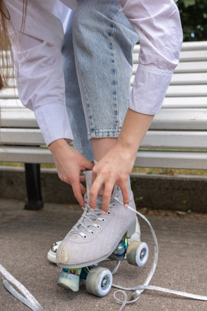 Girl with long hair rollerblading in park. Roller skating quads - popular and safe type of...