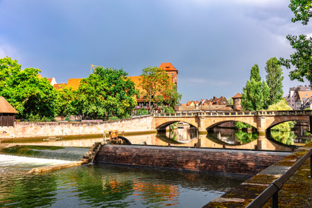 Colourful historic old town with half-timbered houses of Nuremberg. Bridges over Pegnitz river....