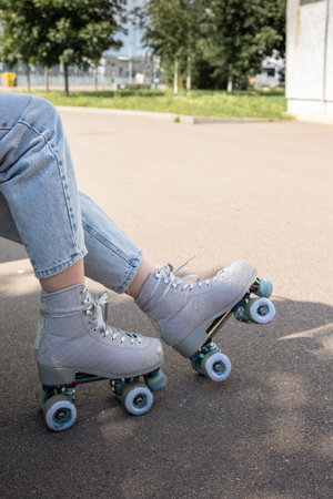 Close-up of girls legs in quad rollerblades. Vertical photo. High quality photo