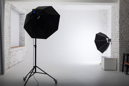 Clear white cyclorama. Light background with professional lighting equipment. Plain wall empty photo...