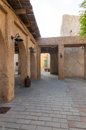 Old town in Al Seef Cultural Historical District on shores of Dubai Creek. Tourist place with old streets, houses and shops, Dubai, UAE. Vertical photoの写真素材