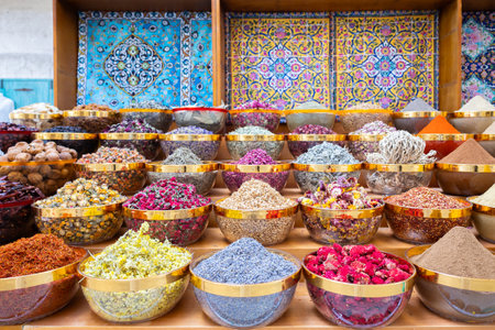 Traditional spices market. Pots and wooden tubs stand in row with colorful tea, spices, fruits,...