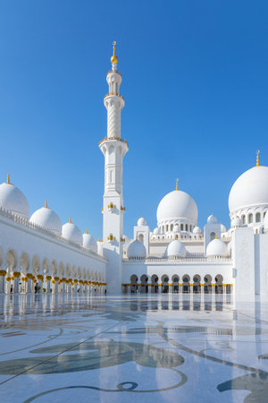 View of Sheikh Zayed Grand Mosque in Abu Dhabi made of snow-white marble with flowers made of precious stones in design and beautiful reflections. Vertical photoの写真素材
