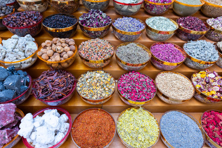 Traditional spices market. Pots and wooden tubs stand in row with colorful tea, spices, fruits, roots, flowers. Street bazaar. Dubai, UAE. Top viewの写真素材