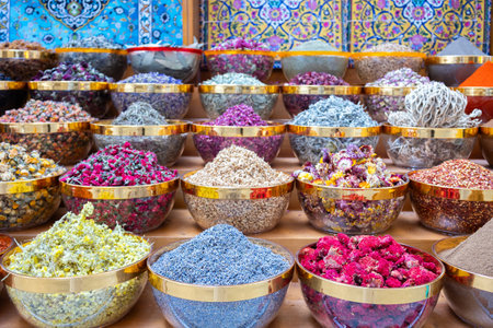 Traditional spices market. Pots and wooden tubs stand in row with colorful tea, spices, fruits,...